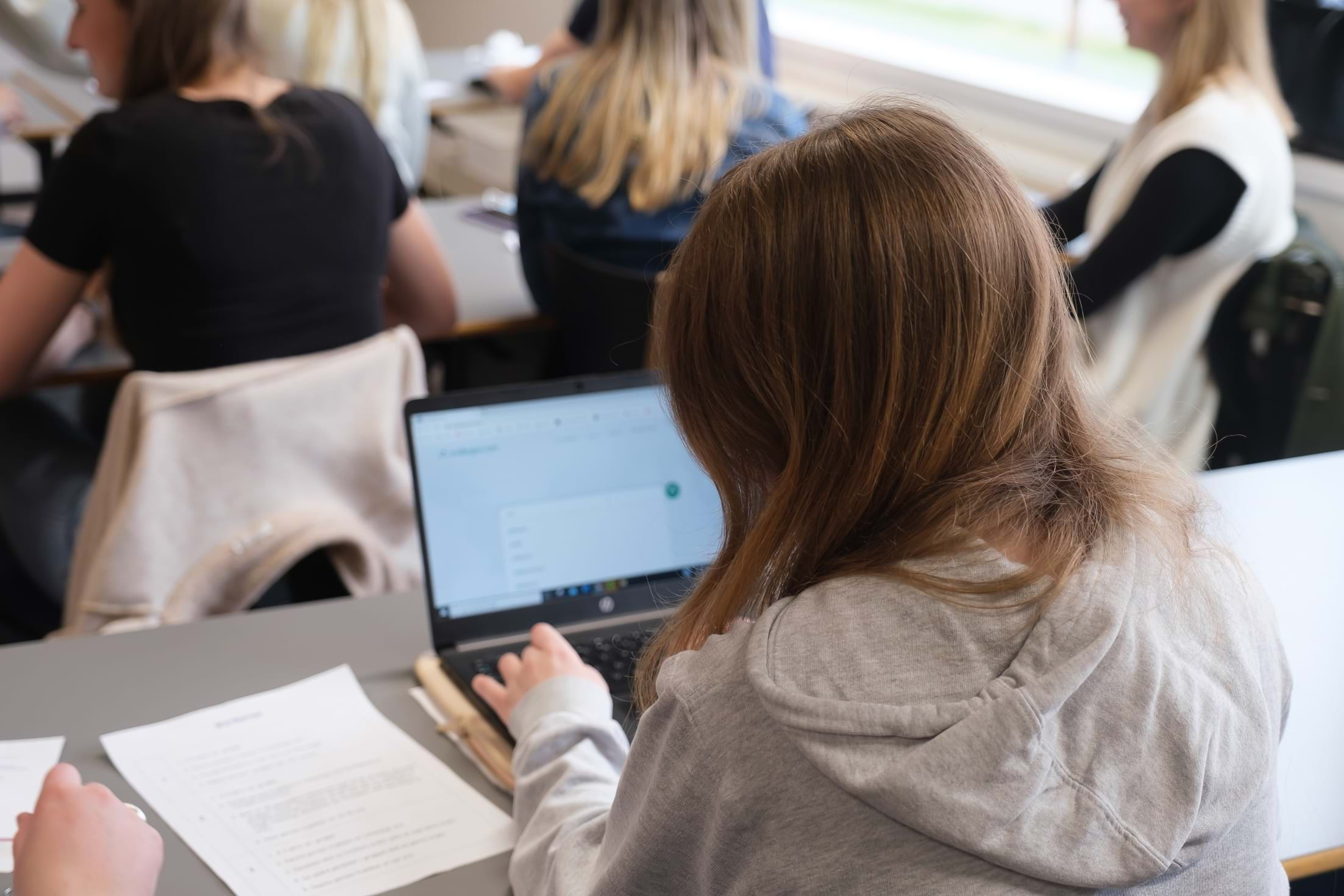 Pige set bagfra laver prøve på computeren